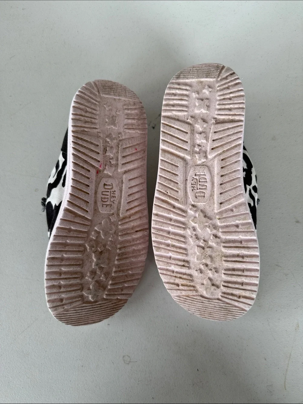 Hey Dude Kids Cow Print Slip-On Shoes in Black & White with Pink Trim